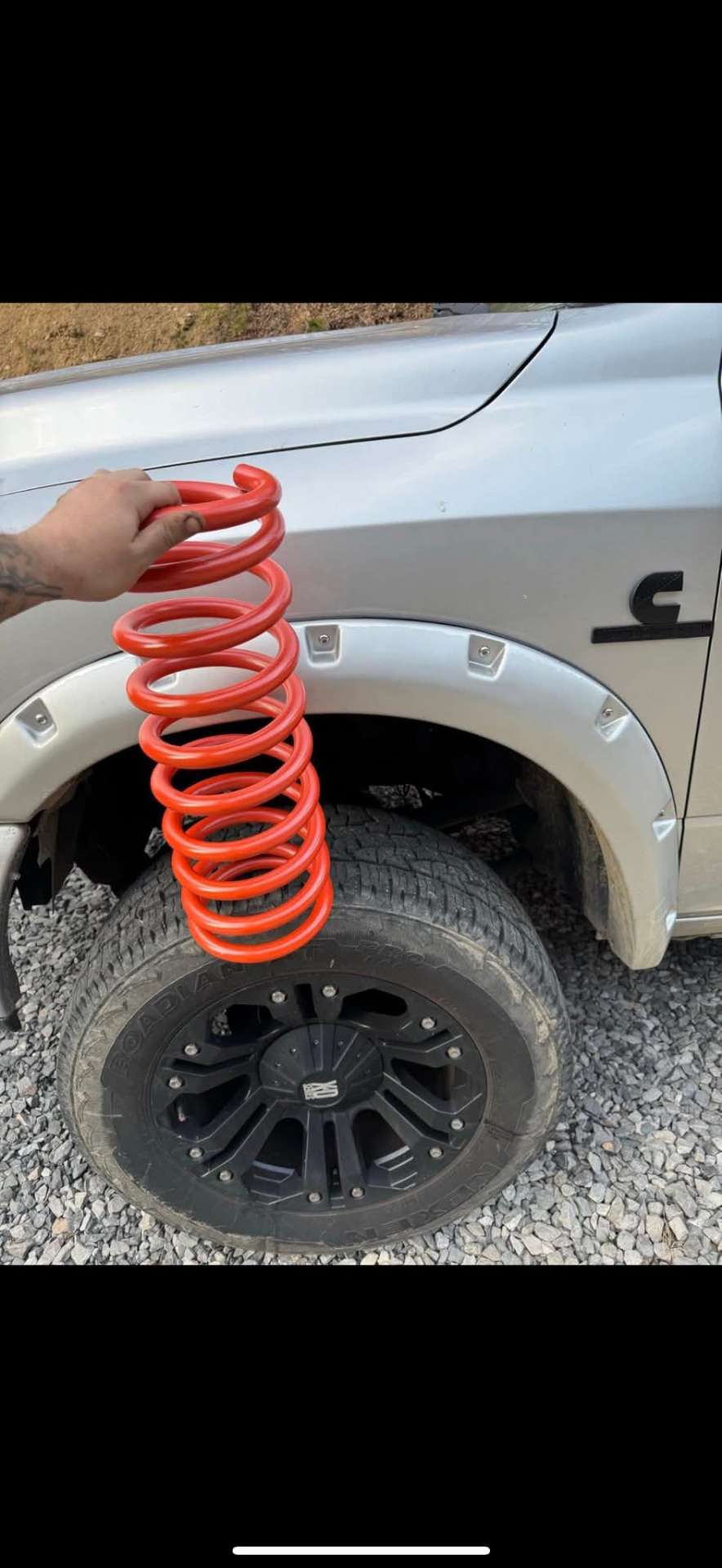Red lift spring on a lifted truck