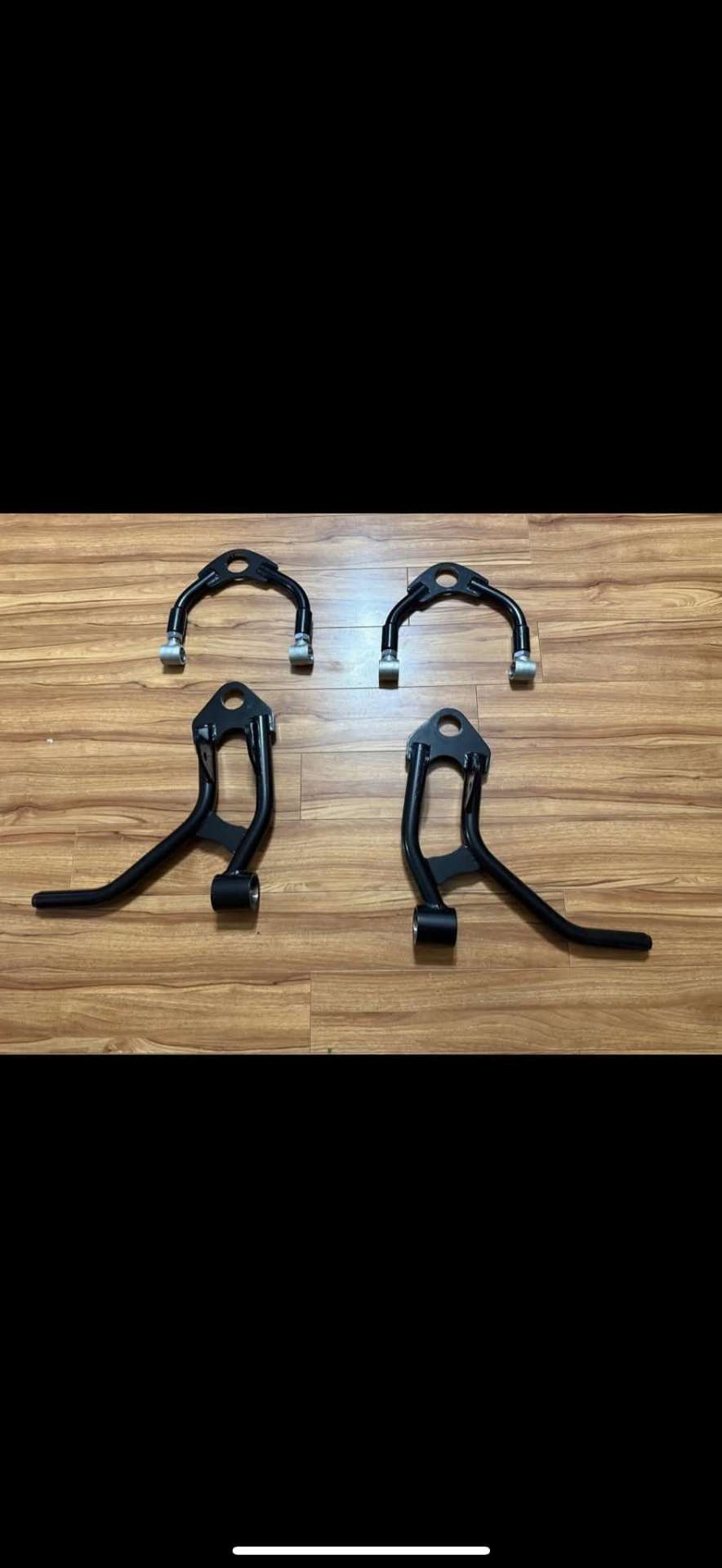 Black powder-coated tubular control arms